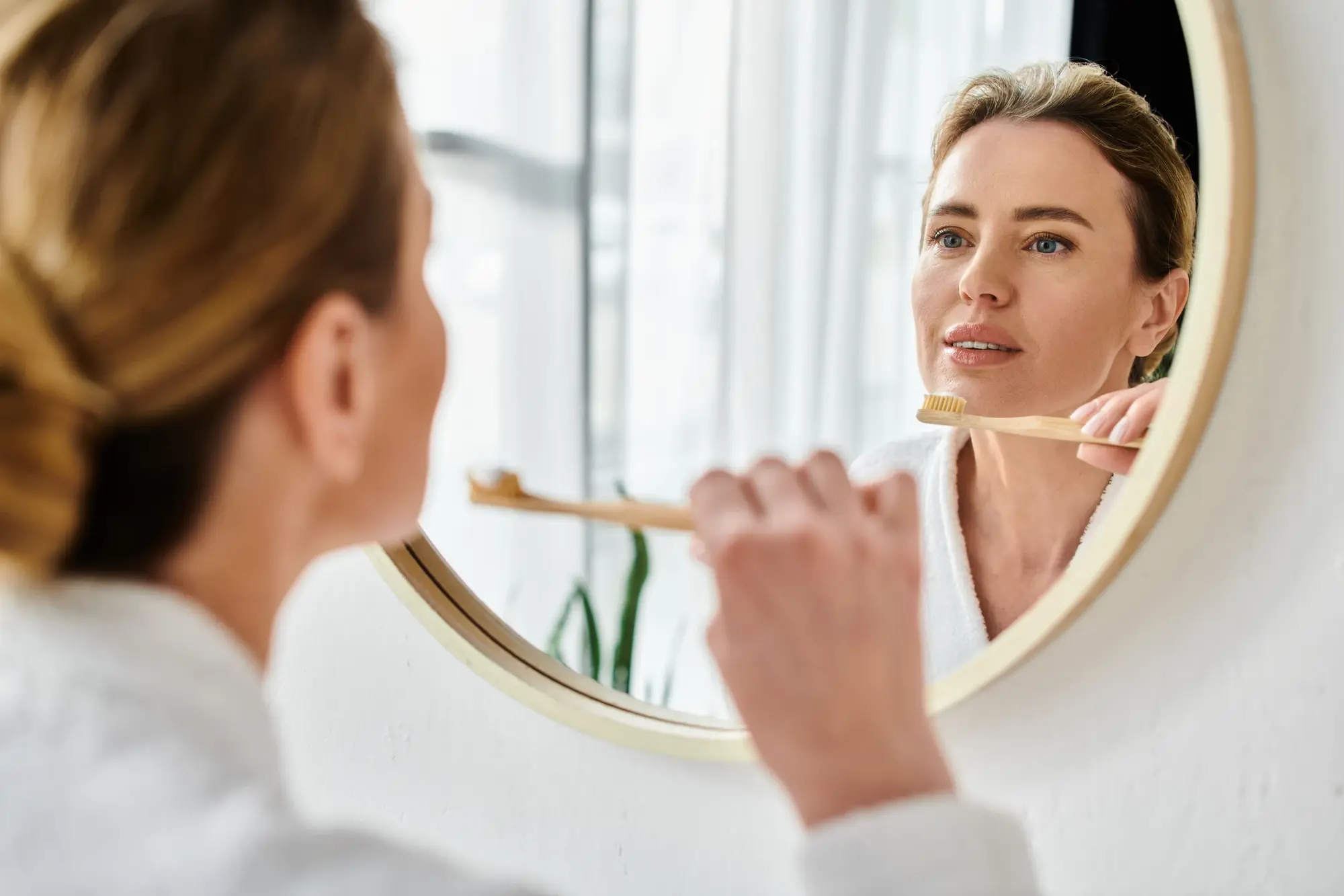 Woman brushing her teeth at home