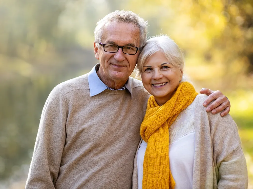 Smiling couple outdoors representing patients who use the Compass Dental membership plan