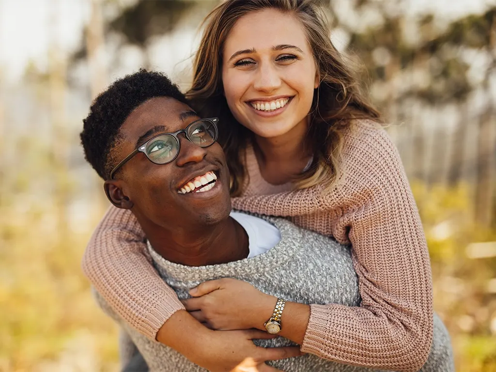 Smiling couple outdoors representing Compass Dental patients